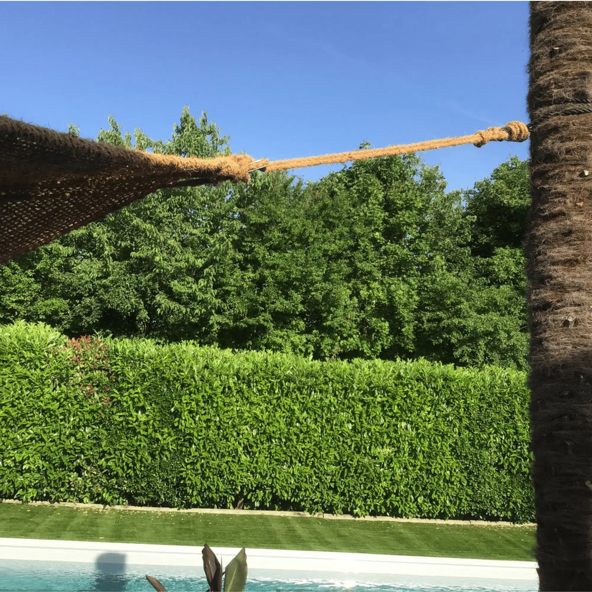 Corde en fibre de coco fixant une toile de coco près d'une piscine